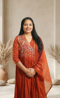 Elegant festive charm in a graceful rust-red ethnic set