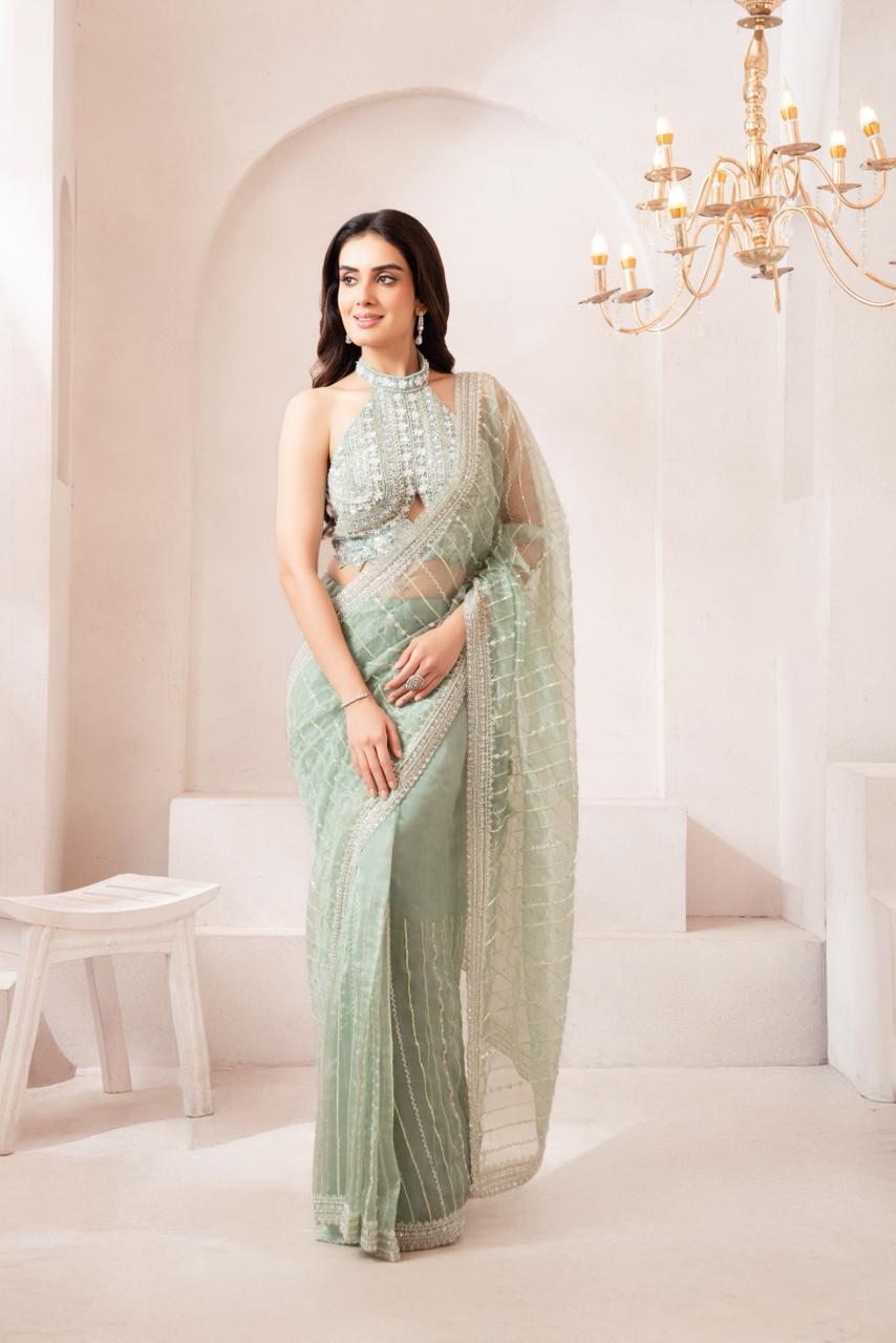 Elegant pastel Green Saree with Statement Halter Blouse for a Modern Festive Look