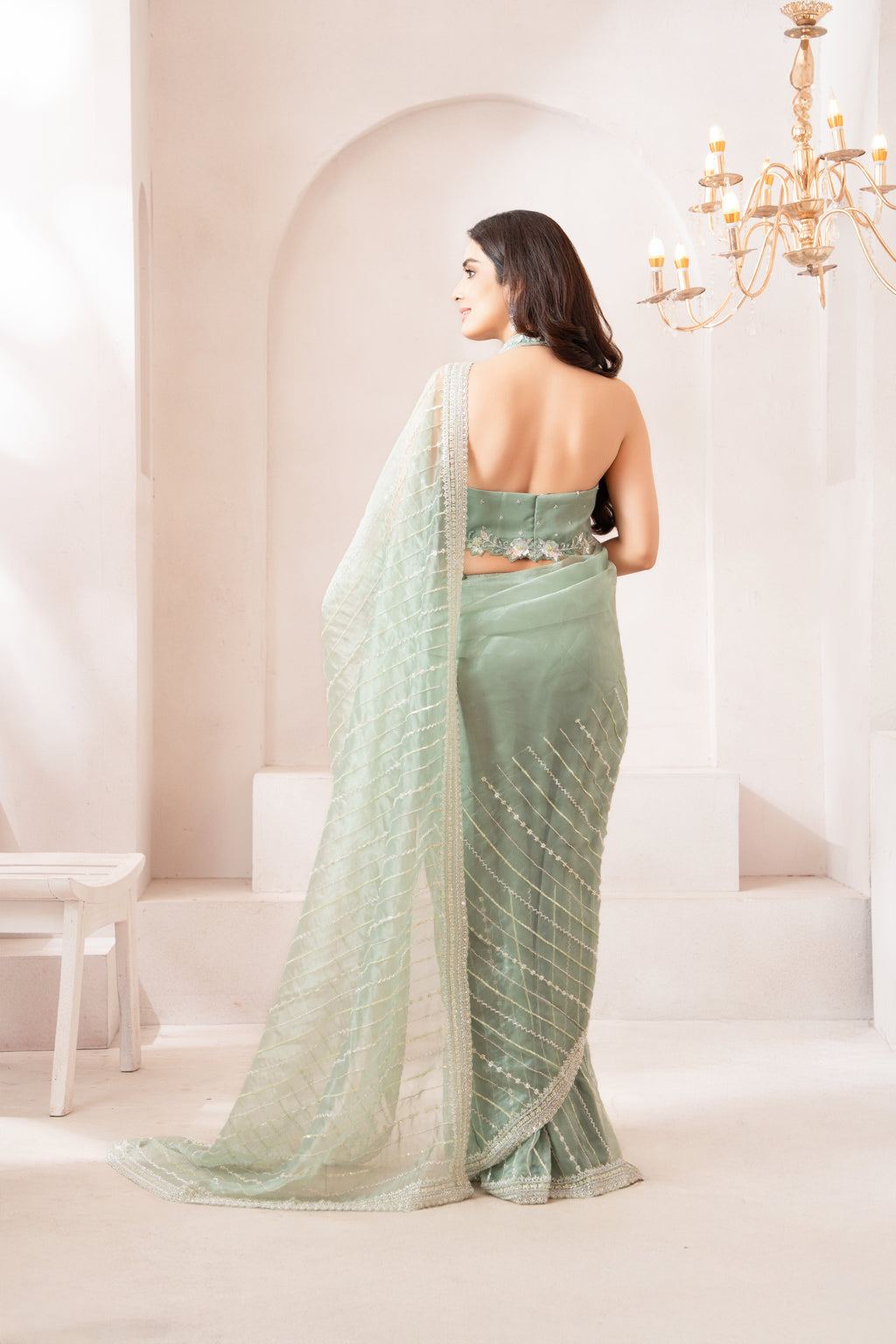Elegant pastel Green Saree with Statement Halter Blouse for a Modern Festive Look
