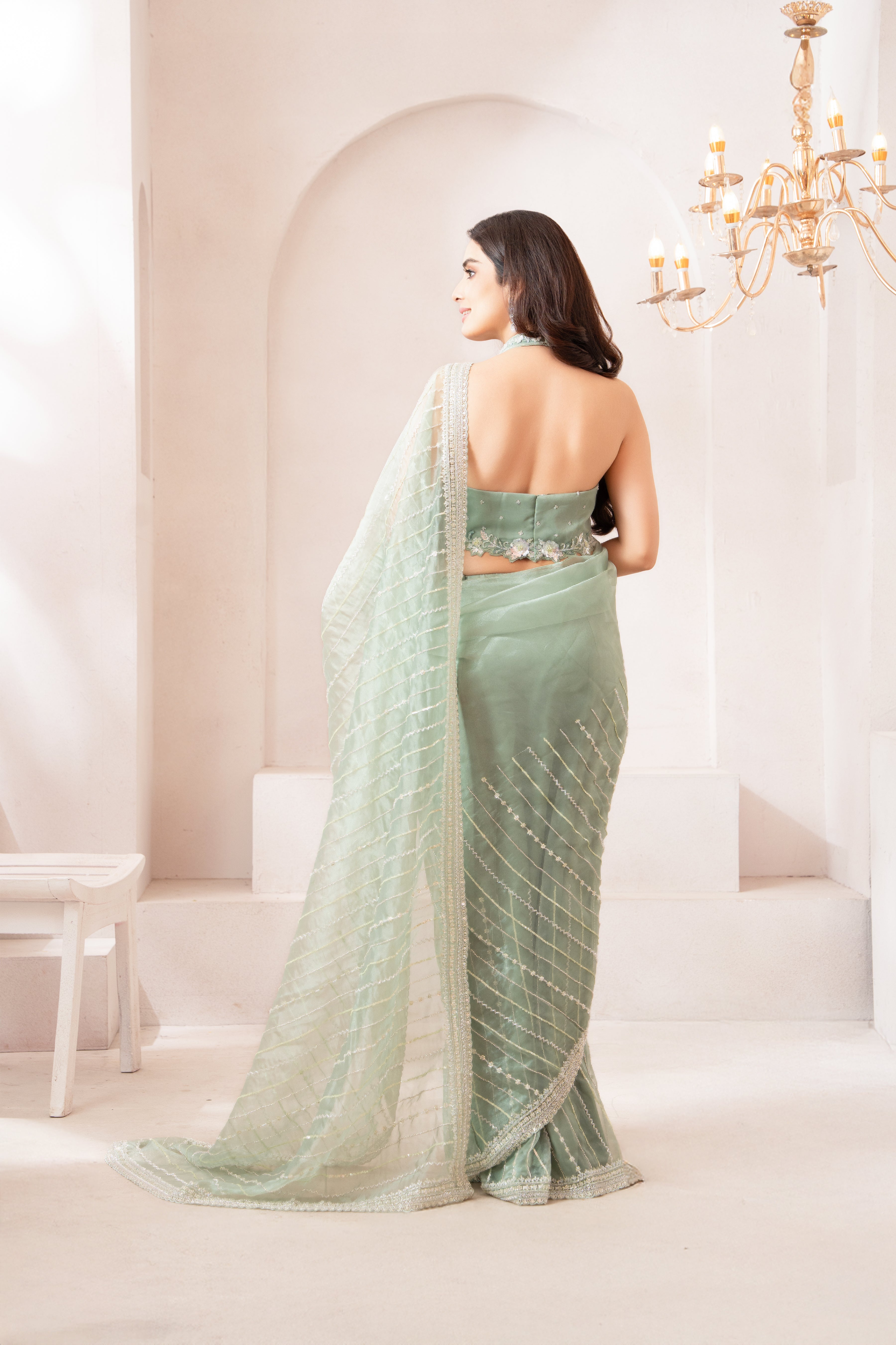 Elegant pastel Green Saree with Statement Halter Blouse for a Modern Festive Look